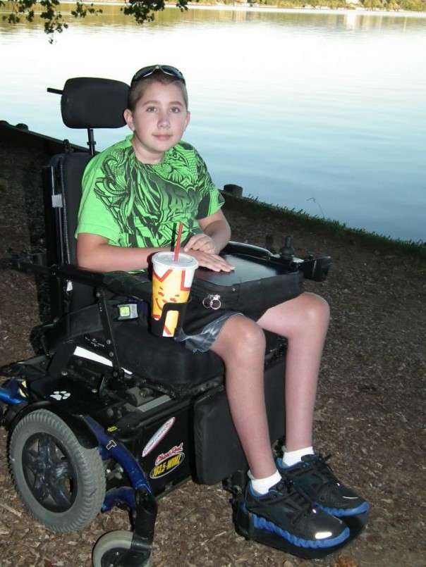 Kyle in his wheelchair by a lake.